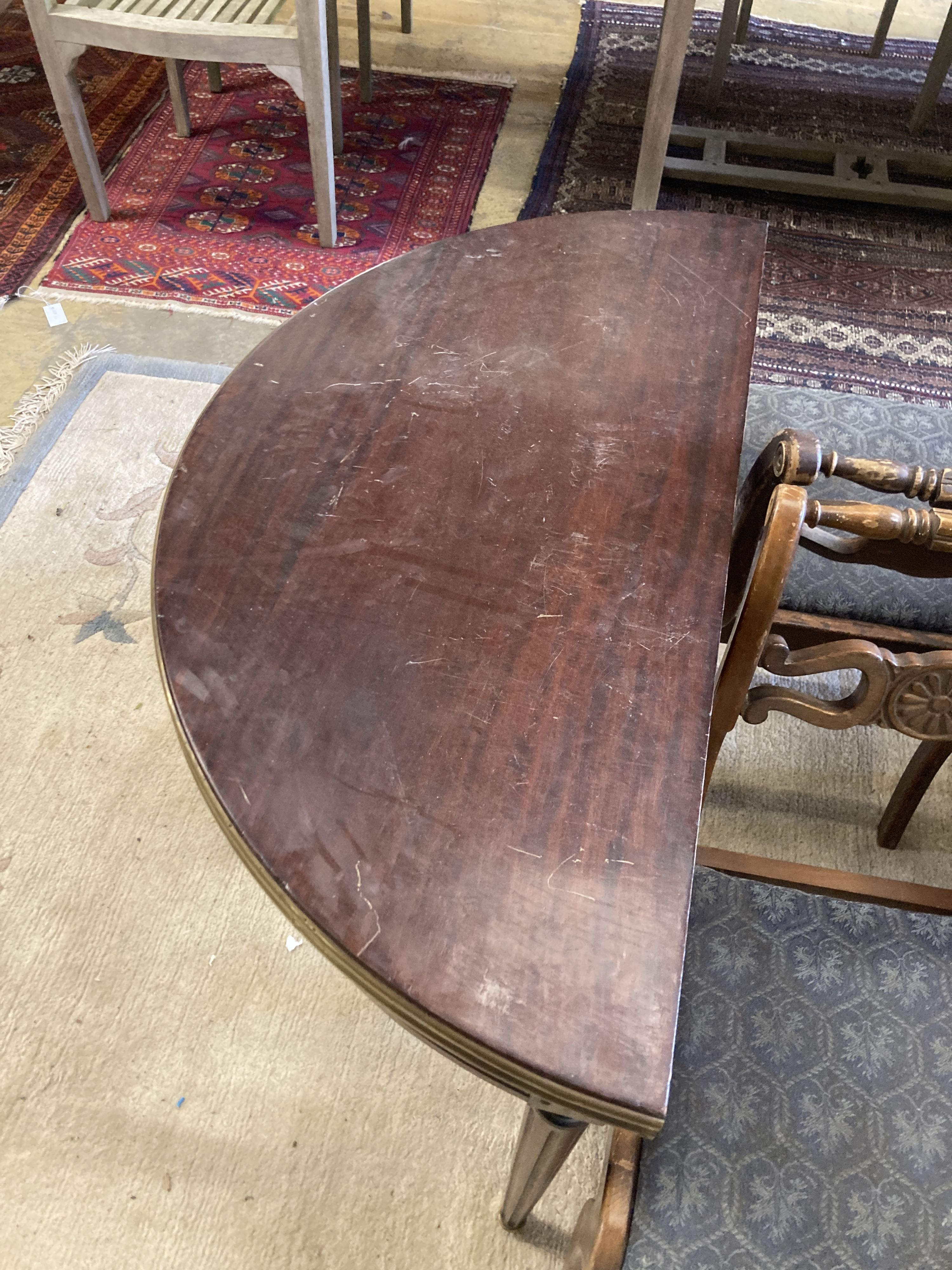 An early 20th century French brass mounted mahogany D shape folding card table, width 91cm, depth 46cm, height 75cm